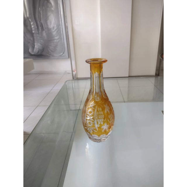A yellow vase made by Nachtmann from high quality Bavarian Crystal that has been cut to clear. Additionally, the vase...