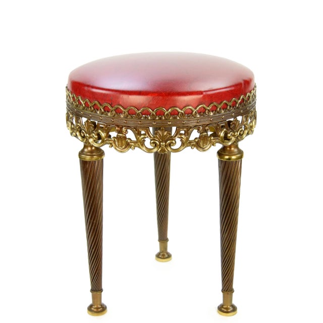 Brass Stool from the 1970s An elegant stool with a brass base adorned with beautiful decorative elements. The stool is in...