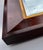 An antique English rosewood wall mirror, circa 1901, retaining the original label of London picture frame maker Ernest...