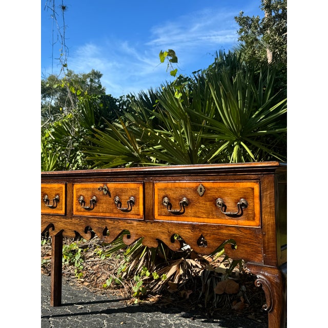 A beautiful 18th-century Georgian-style oak low dresser with exceptional warmth, character, and traditional English...