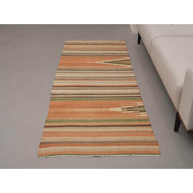 Vintage Hand-Knotted runner rug is a semi-antique vintage runner rug. The '70s Eastern region of Anatolia's unique rug is...
