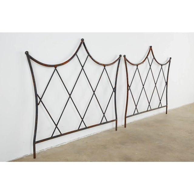 Dramatic midcentury pair of twin headboards made in the Regency taste. Features a handcrafted wrought iron frame with...