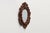A richly carved French oval wall mirror dating to around 1900, distinguished by its sculptural openwork frame and...