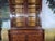 An elegant two-part display cabinet, 19th century. The upper section opens with two glass doors The lower section features...