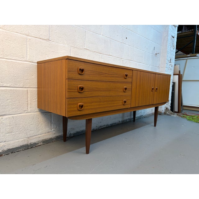 Mid-century charm into your home with this beautifully designed Danish-style sideboard, featuring a warm faux teak veneer...