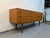 Mid-century charm into your home with this beautifully designed Danish-style sideboard, featuring a warm faux teak veneer...