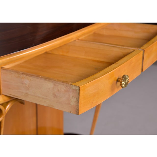 Found in Italy, this console dates from approximately 1960. This demi-lune shaped console is made of a blond wood (we are...