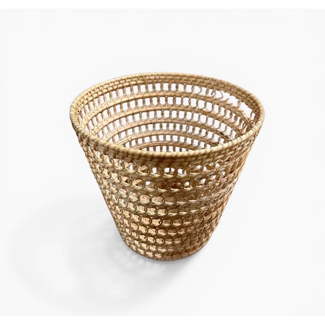 Handwoven rattan waste basket produced in denmark during the 1960s–1970s. the basket features an open woven construction...