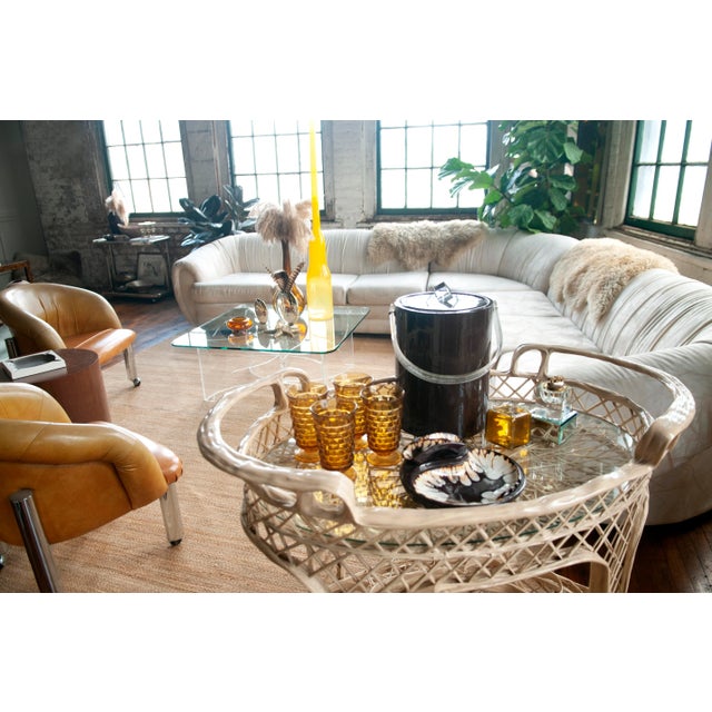 Mid-century Spun Fiberglass Bar or Tea Cart: featuring dual-level shelving with glass insert and a rare speed rack. The...