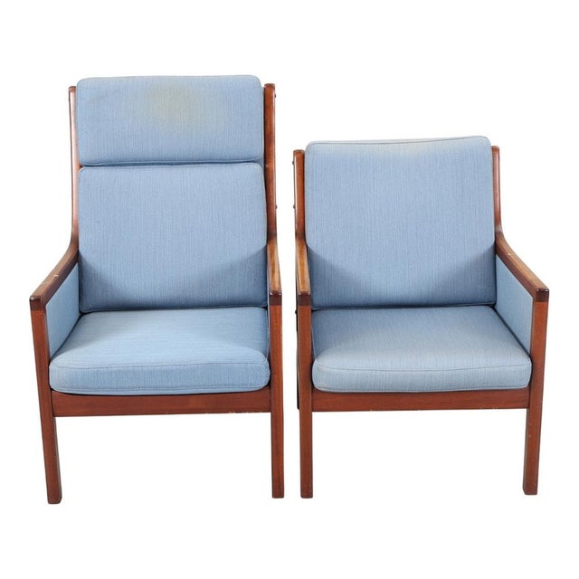 High-back armchair, low-back armchair and footstool with solid, lacquered mahogany frame, upholstered in blue wool....