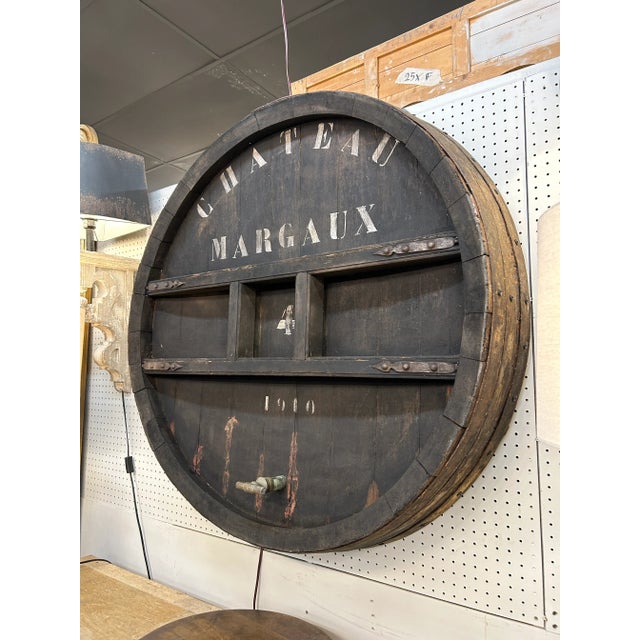 Transport your space to the vineyards of Bordeaux with a Ca. 1910 French Château Margaux Wine Barrel Top Façade. Once part...