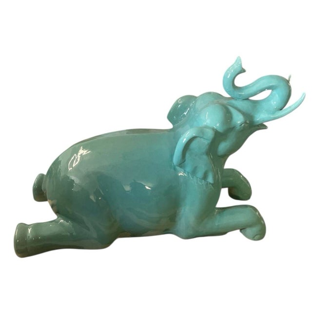 A captivating mid-century vintage Italian glazed ceramic sculpture of a reclining elephant. This substantial piece...