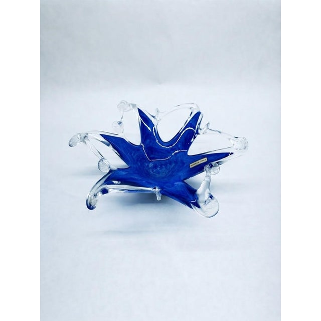 Striking mid-century studio art glass bowl featuring a vibrant cobalt blue center encased and extended by dynamic, free-...