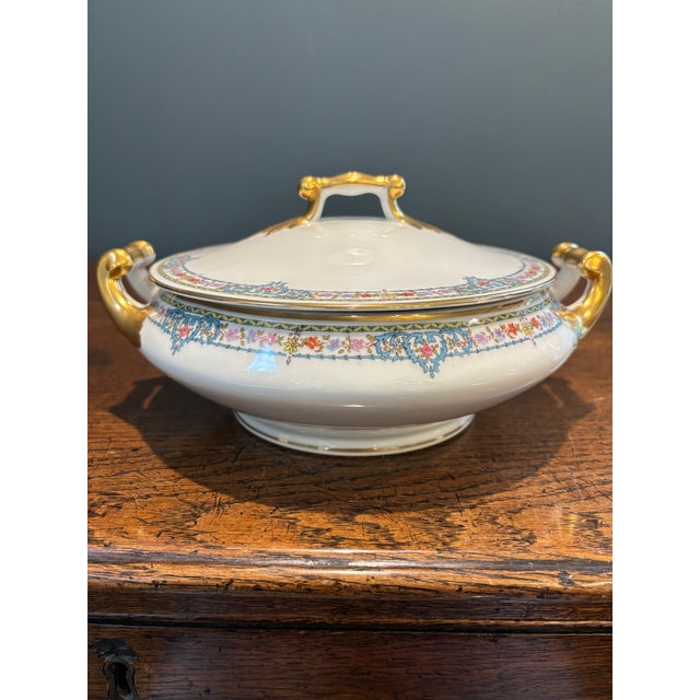 **Story & Design:** Elevate your tablescape or china cabinet with this exquisite antique French porcelain covered serving...
