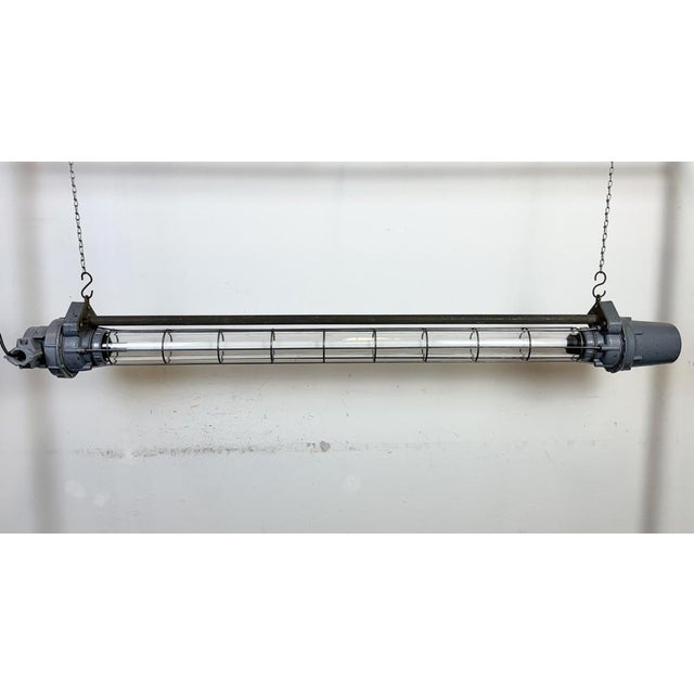 This grey industrial tube light was made in Ukraine in former Soviet Union during the 1970s. It is made of an aluminium,...