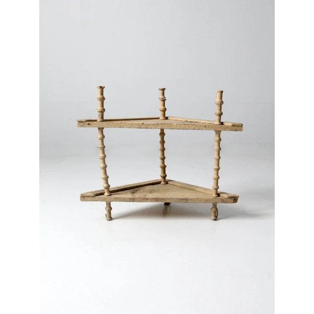 An antique spool shelf riser dating to the Victorian era. This charming stand features a turned wooden spool frame...
