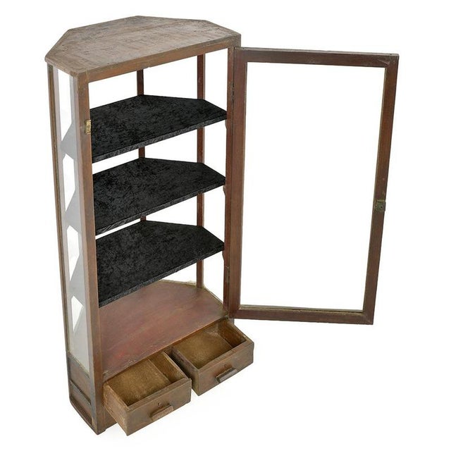 This antique display case, with its unique polygonal silhouette, combines the warmth of wood and the transparency of glass...