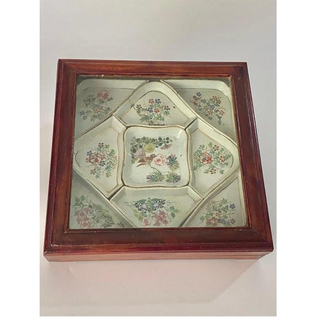 In a wood box, a set of serving bowls in porcelain. there are Hand painted, with a mark underneath. Some have a small...