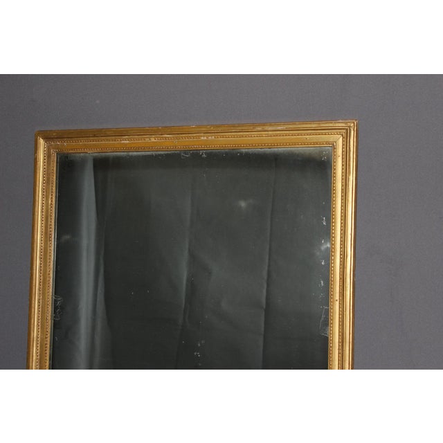 Louis XVI style mirror in carved and gilded wood, original paneled backing, late 18th or early 19th century, overall in...
