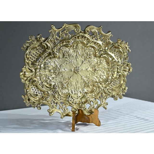 This tray, called a middle table, in gilded bronze in a rocaille style, is centered with torches placed in a star shape....