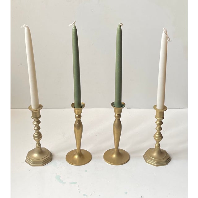 A total of 4 candlestick holders in solid brass - consisting of two diffrent pairs. Manufactured in Denmark circa 1970....