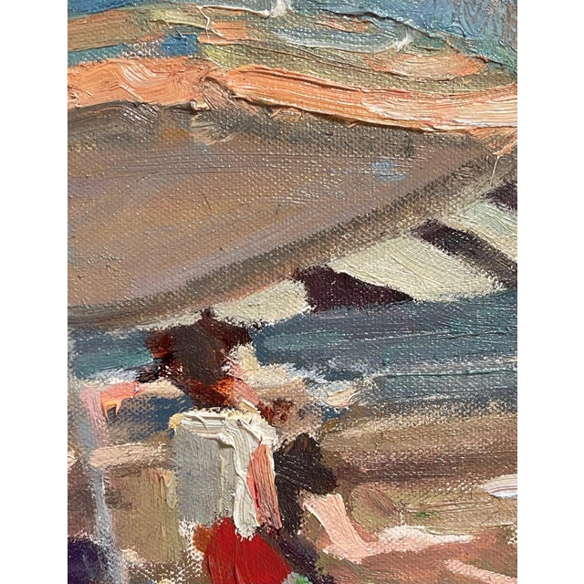 This oil on canvas captures a lively beach scene, filled with sunbathers and colorful umbrellas that create a vibrant...