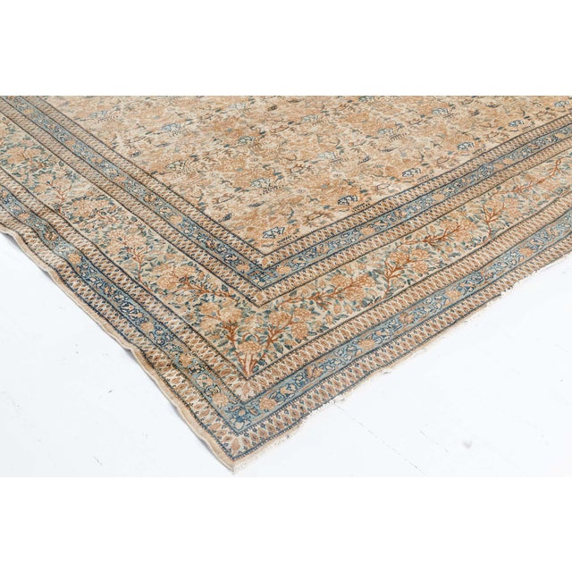 An early 20th century Persian Kirman (Kerman) antique carpet, the camel field with a dense overall design of rows of ice...