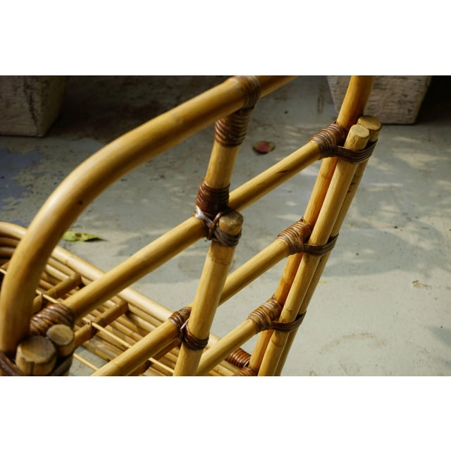 - A rattan lounge chair - In the style of Paul Frankl - Also usable as a couch extension - Has been reupholstered