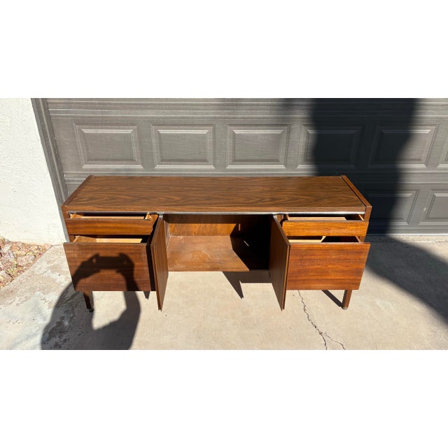 This sleek mid-century modern credenza by Kimball (see mark in photos) is a fine example of functional style and quality...