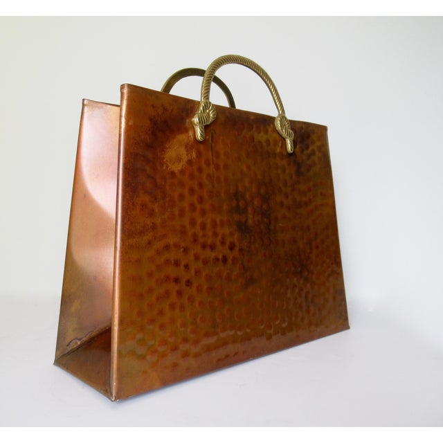 Vintage; Hollywood Regency era hand forged, hammered copper magazine holder, with polished brass, tassel-rope motif,...