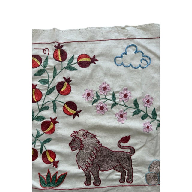 Hand-embroidered Suzani panel from Uzbekistan, worked in fine floss on a cream cotton ground. Three rose-brown lions...