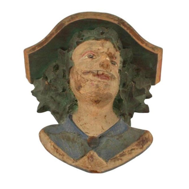 Carved Wood Figural Wall Shelf. Wall shelf features a carved and painted mascaron-like human male face with expressive...