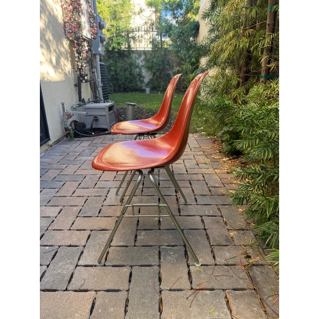 Authentic vintage Eames Fiberglass Side Chairs by Herman Miller, designed by Charles and Ray Eames. Each chair features an...