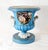 A magnificent pair of French Sèvres-style porcelain urns with a striking sky-blue ground Each urn features a finely...