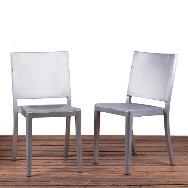 A stacking Hudson Chair in brushed aluminum by Philippe Starck for Emeco. Multiple available. 17 ¾ inches wide by 20 ½...