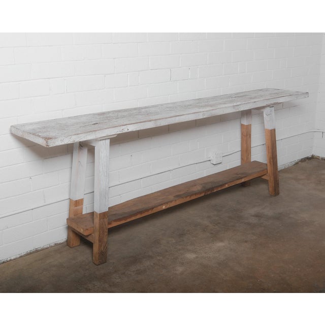 This beautifully aged rustic vintage console table showcases a distressed whitewashed finish, adding character and charm...