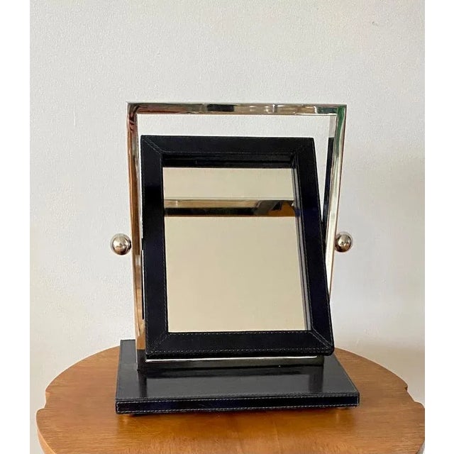 Vintage postmodern makeup vanity small table mirror combines dark blue vinyl and chrome.