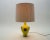 Great strong yellow. In beautiful contrast to the brown coating. With original lampshade. A fine ceramic table lamp in an...