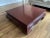 A large square Kang style square coffee table with a sturdy, hardwood frame in a deep red painted finish by Baker...