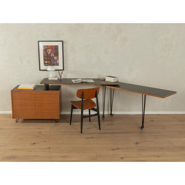 A unique desk from the 1960s. High-quality construction consisting of a teak veneer container with two cabinet doors and...