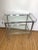 Vintage mid- century chrome and glass two tiered bar cart. Glass are set in place and do not come out. Cart moves freely...