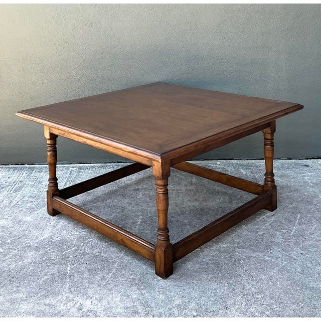 This substantial vintage coffee table is a beautiful expression of rustic elegance, drawing inspiration from classic...