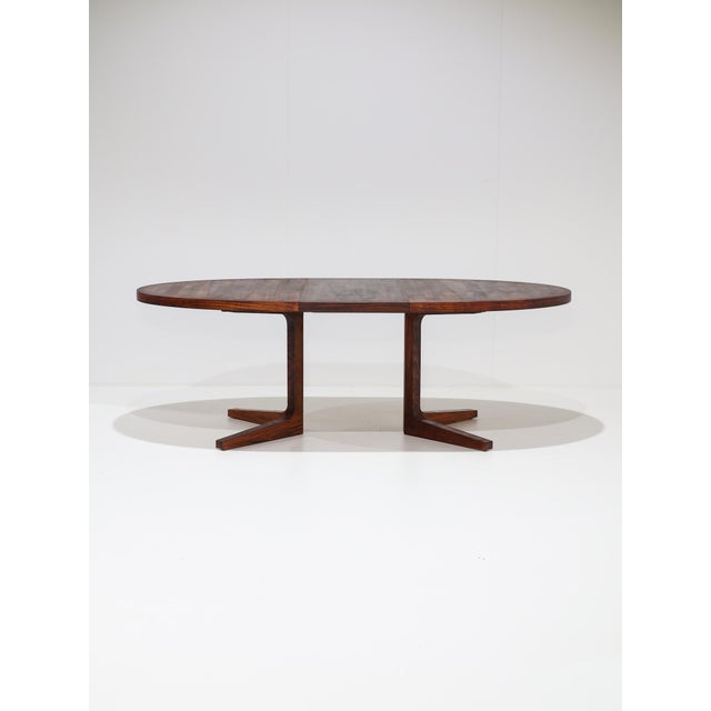 Rare oval extendable dining table manufactured by dyrlund in denmark during the 1960s. This beautiful table is crafted...