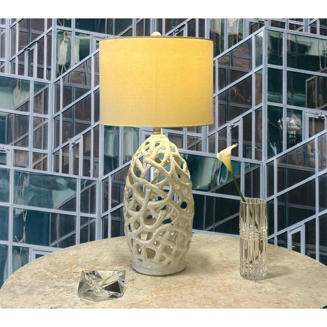 Add sculptural dimension, airy negative space, and organic texture to your interior with this pierced ceramic table lamp....