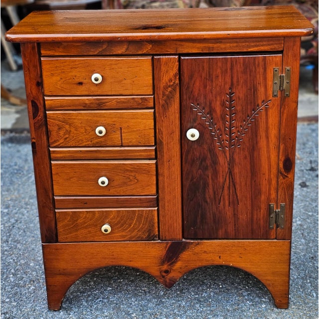 Early American Style Stained Pine Side Chest Cabinet. Measures 29.5" in width, 13" in depth and 32" in height.