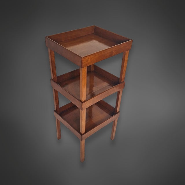 A three-tiered Biedermeier-era serving stand, crafted entirely from solid wild cherry wood. The design is classically...