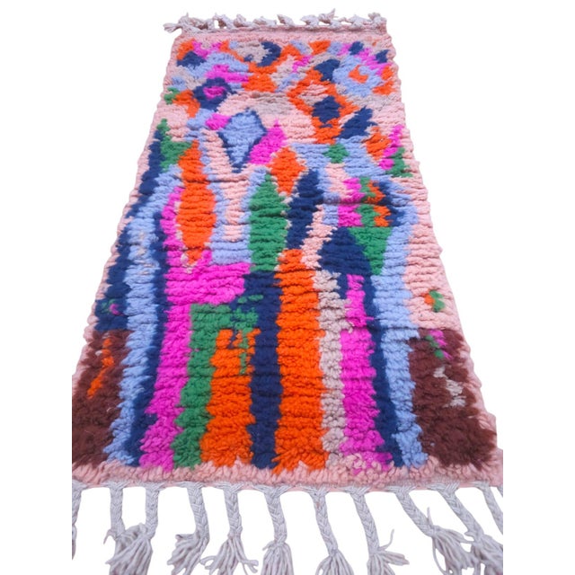 Elevate your bath space with this authentic, hand-knotted creamy Moroccan Azilal luxury rug. Showcasing a vibrant pink...