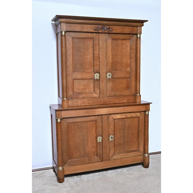 This two-body sideboard opens in the lower part with a double knockout panel door and miter-cut frame with interior...