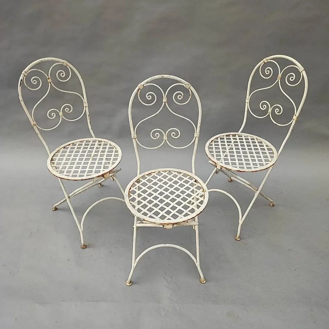 Set of 3 white solid iron folding garden chairs, 1900s period.