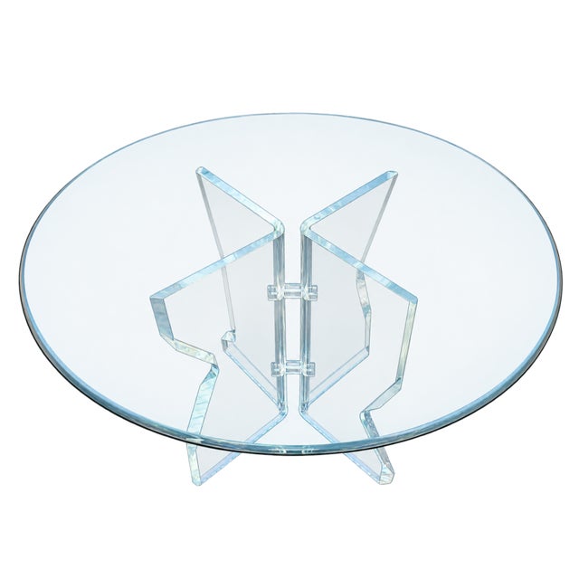 This striking late-20th-century postmodern round glass dining table features a dynamic, angular form that gives it a...